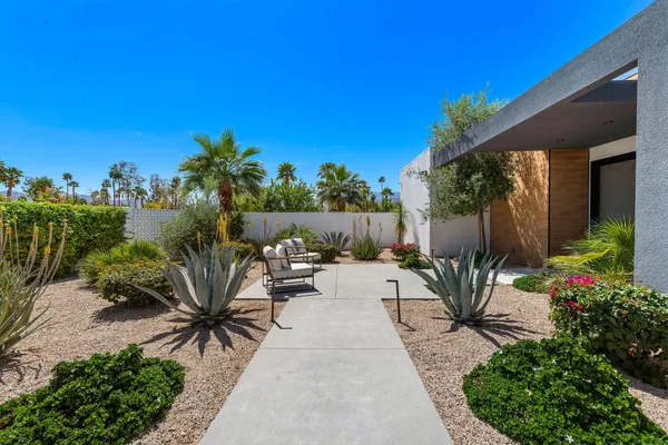 a view of a backyard with sitting area