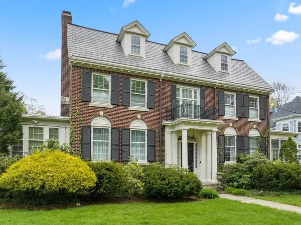 a front view of a house with garden and porch