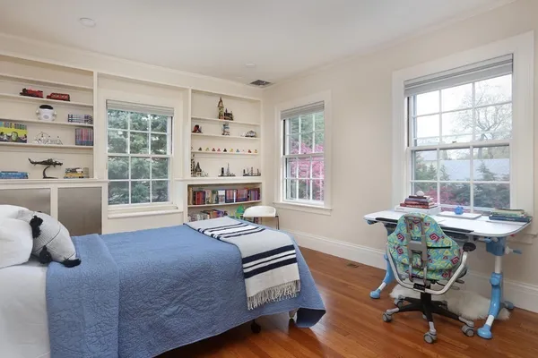 a bedroom with furniture and a window