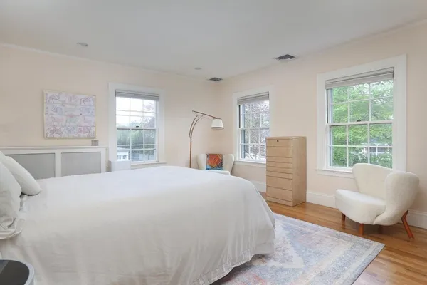 a spacious bedroom with a bed and glass window