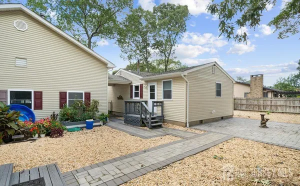 a view of a house with backyard and sitting area