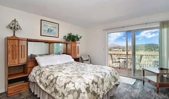 a bedroom with a large bed and a large window