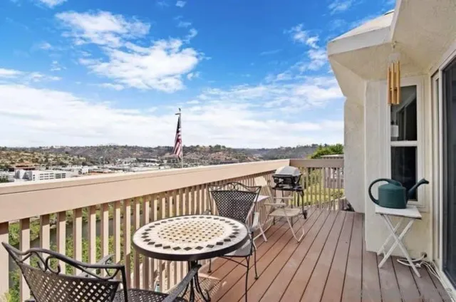 a view of a balcony with chair and wooden floor