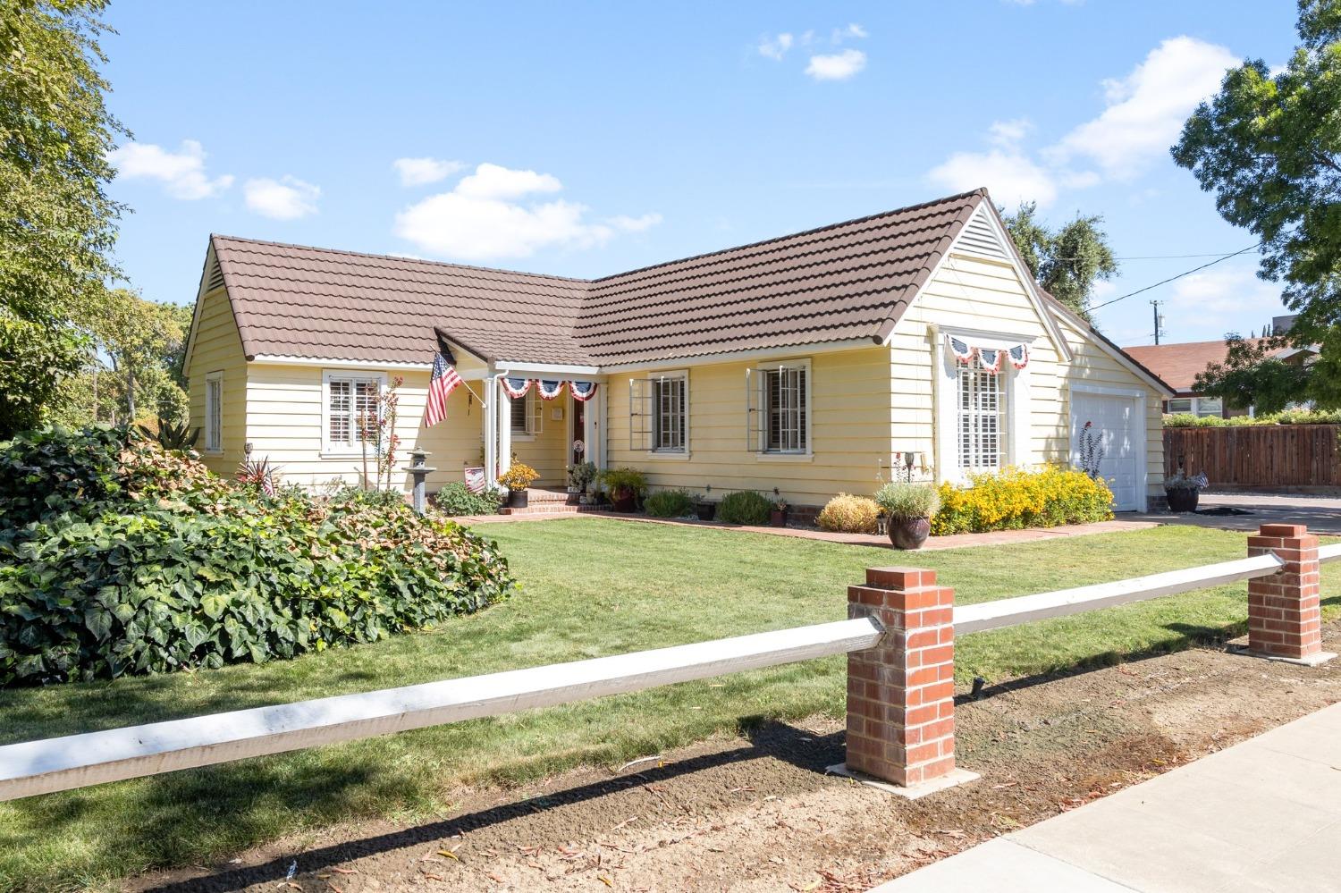a front view of a house with a yard and porch