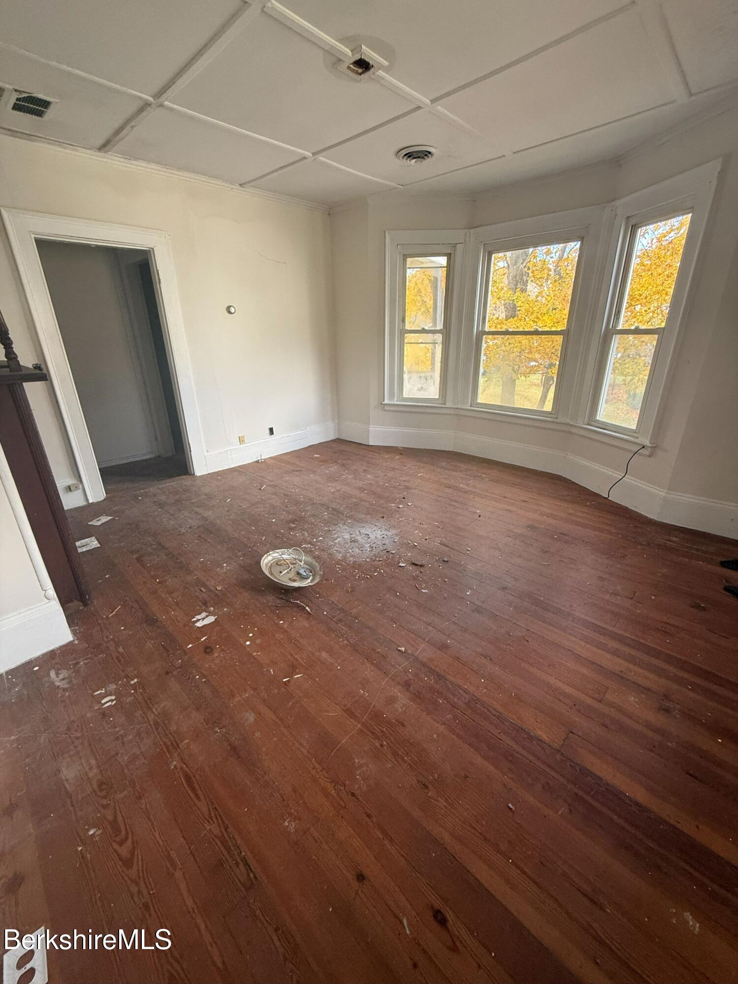 32-38 Spring Street North Adams, MA 01247 - Photo 26 of 32 wooden floor in an empty room with a window