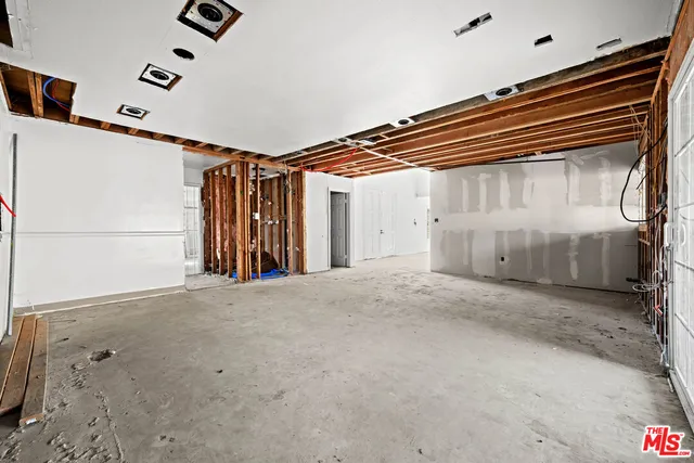 a spacious bedroom with a large bed and a couch