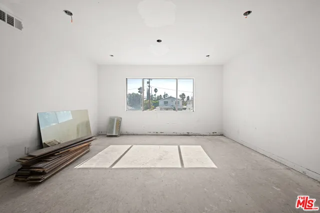 a view of a patio with couches potted plants and a big yard