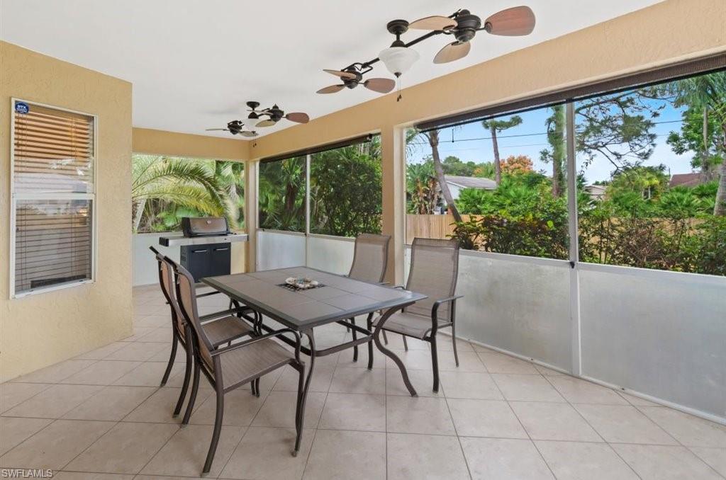 18269 Columbine Road Fort Myers, FL 33967 - Photo 24 of 29 a view of a dining room with furniture a chandelier and wooden floor
