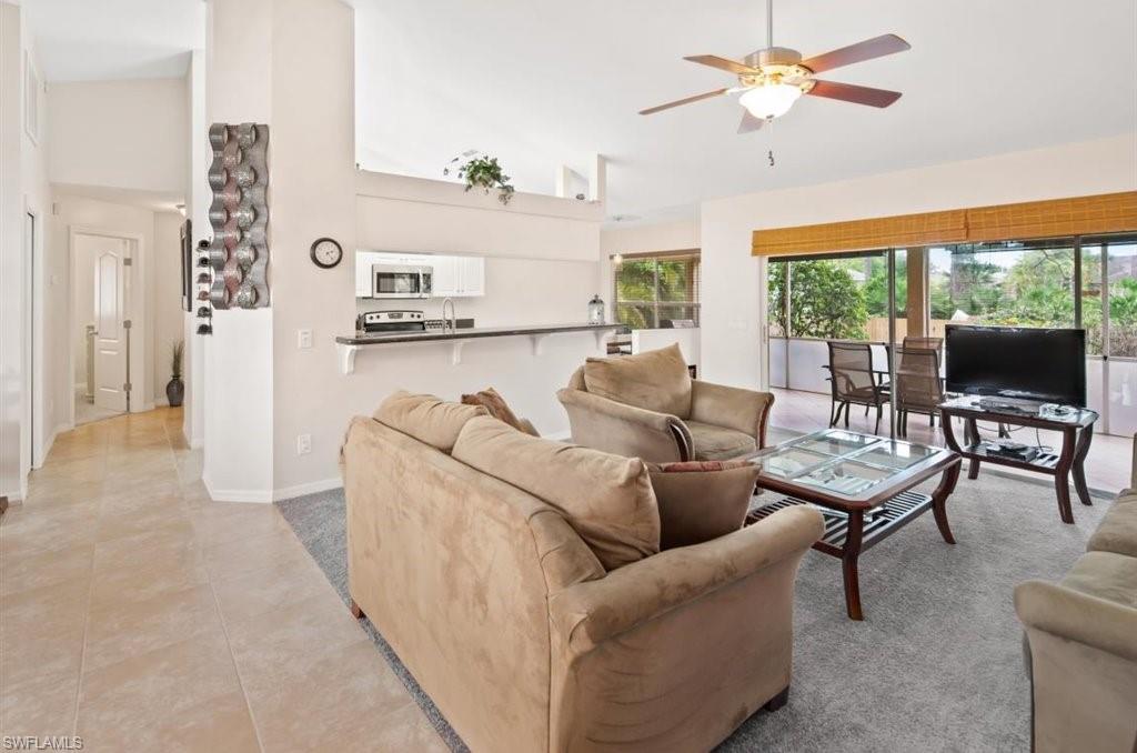 18269 Columbine Road Fort Myers, FL 33967 - Photo 3 of 29 a living room with furniture a flat screen tv and a large window