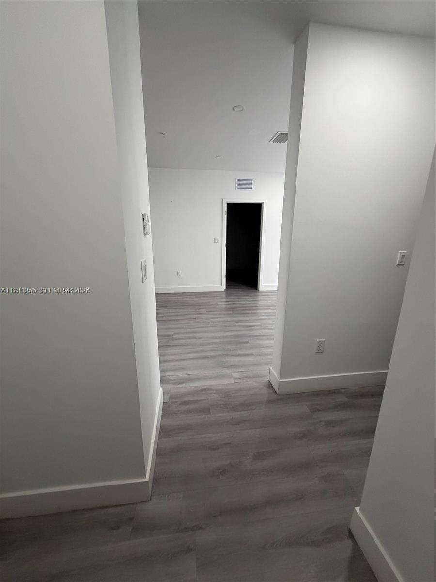 853 East 24th Street, Unit 305 Hialeah, FL 33013 - Photo 8 of 20 a view of empty room with wooden floor