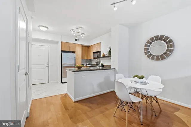 a kitchen with a table chairs a sink and cabinets