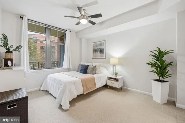 a bedroom with bed and a large window