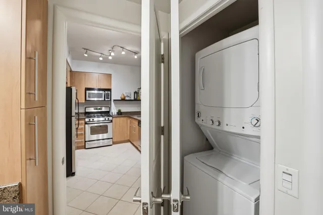 a view of kitchen with refrigerator and cabinets