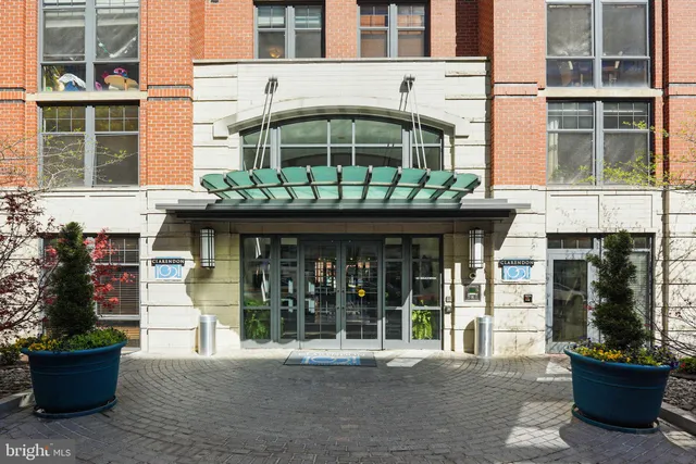 a front view of a building with a garden