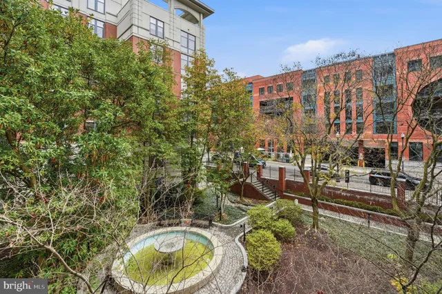 a backyard with table and chairs and potted plants