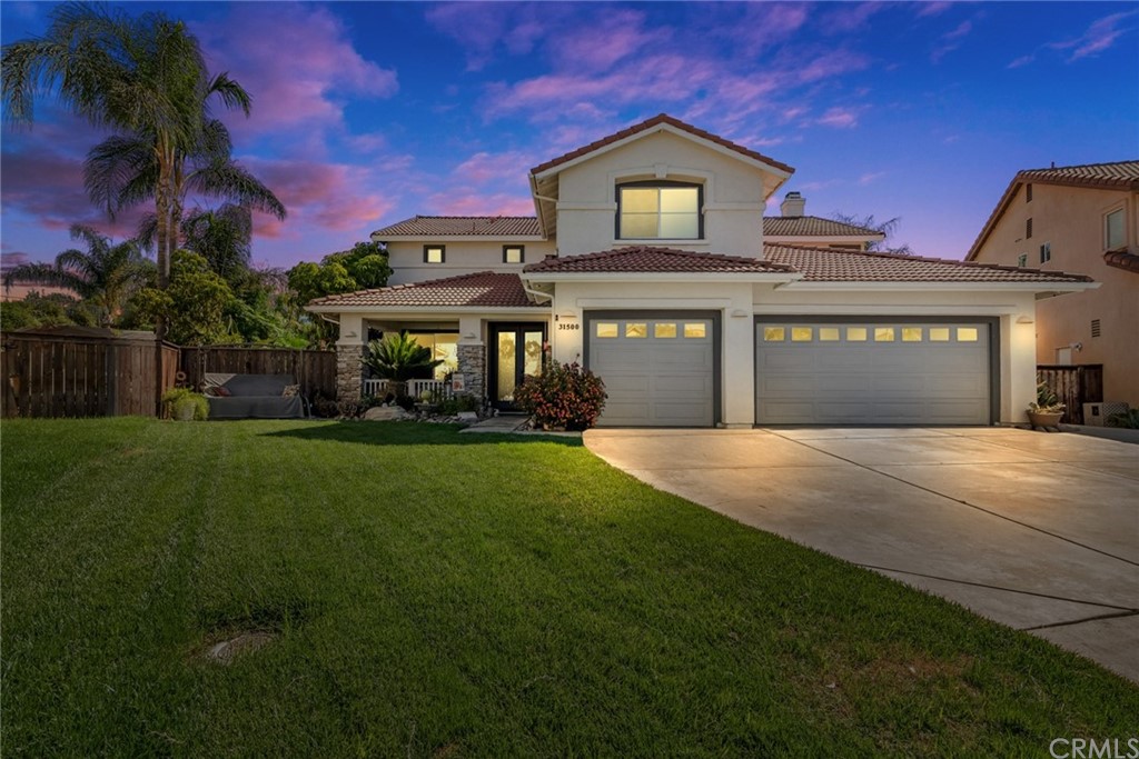 a front view of a house with a yard and garage