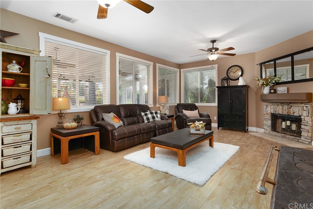 31500 Britton Circle Temecula, CA 92591 - Photo 13 of 68 a living room with furniture a fireplace and a large window