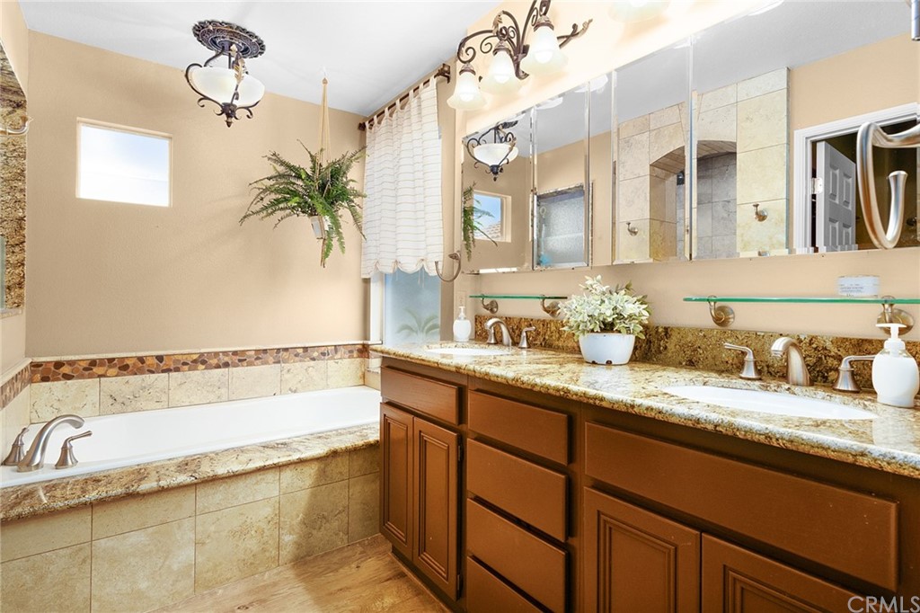 31500 Britton Circle Temecula, CA 92591 - Photo 26 of 68 a bathroom with a granite countertop sink and a bathtub
