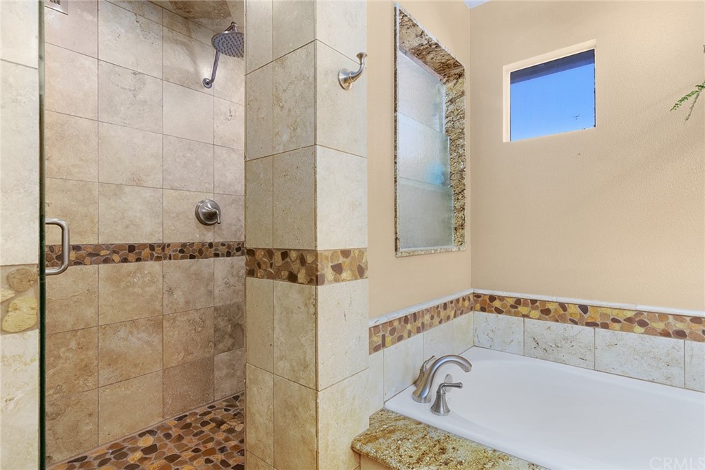 31500 Britton Circle Temecula, CA 92591 - Photo 27 of 68 a bathroom with a bathtub and a shower