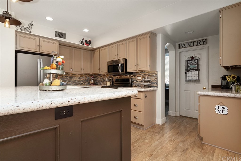 31500 Britton Circle Temecula, CA 92591 - Photo 4 of 68 a kitchen with granite countertop a refrigerator stove top oven and sink