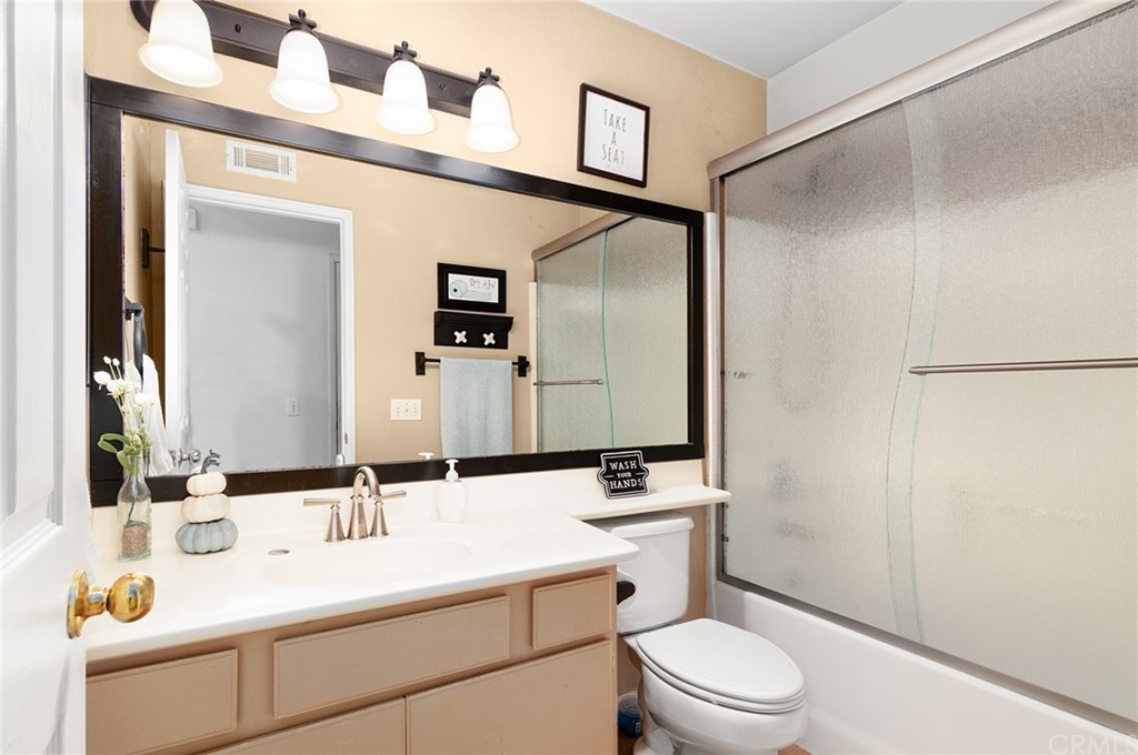 31500 Britton Circle Temecula, CA 92591 - Photo 33 of 68 a bathroom with a sink a toilet a mirror and vanity