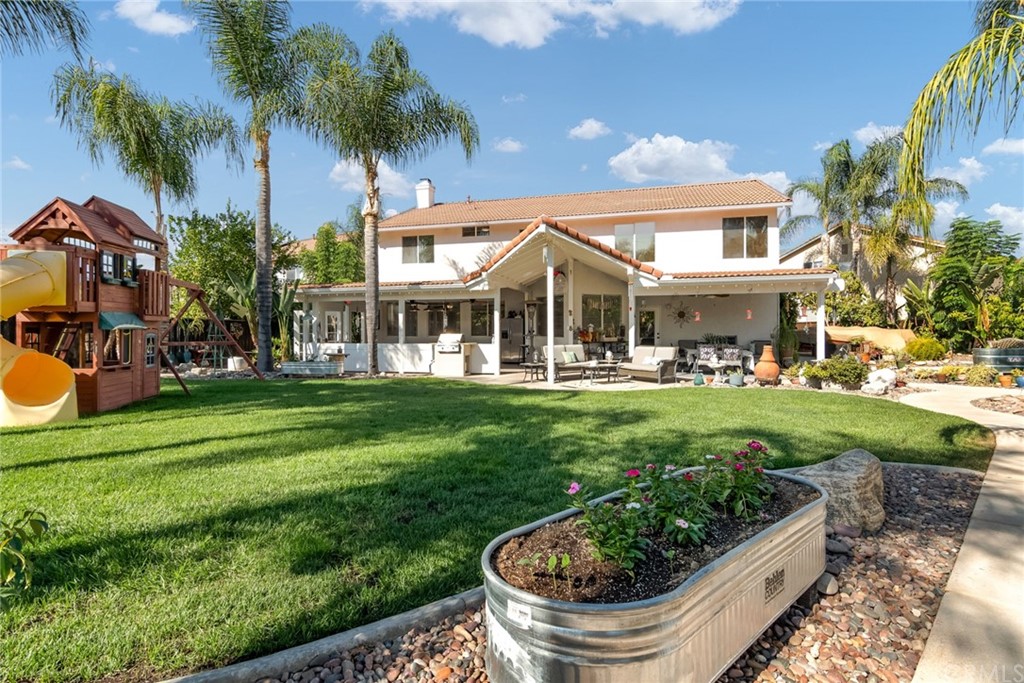 31500 Britton Circle Temecula, CA 92591 - Photo 44 of 68 a view of a white house with a yard table and chairs