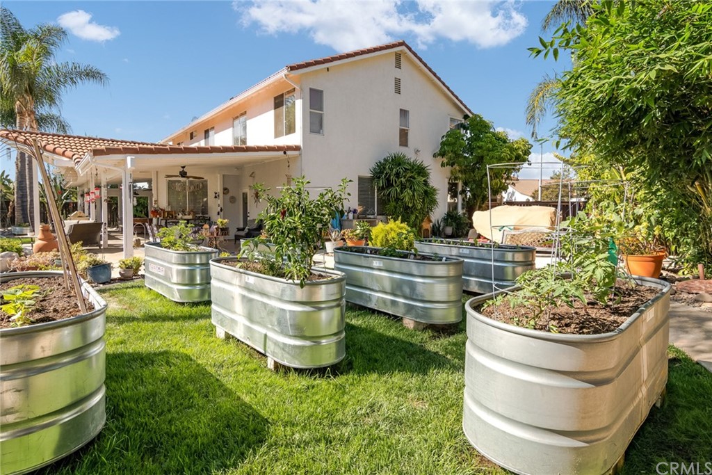 31500 Britton Circle Temecula, CA 92591 - Photo 49 of 68 a front view of a house with a garden and patio