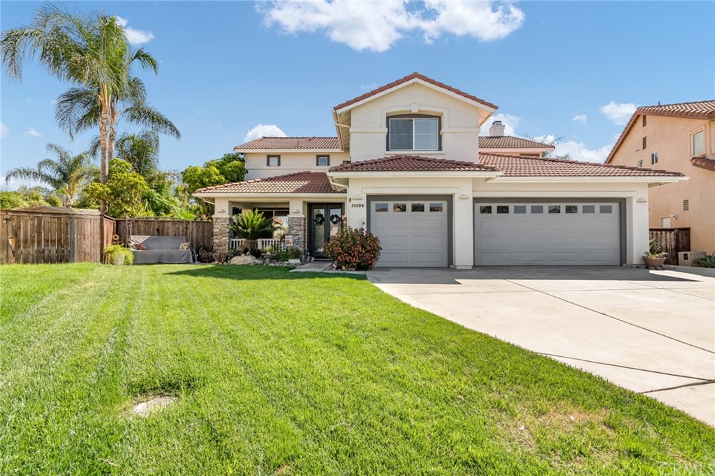 31500 Britton Circle Temecula, CA 92591 - Photo 61 of 68 a front view of a house with a yard and garage