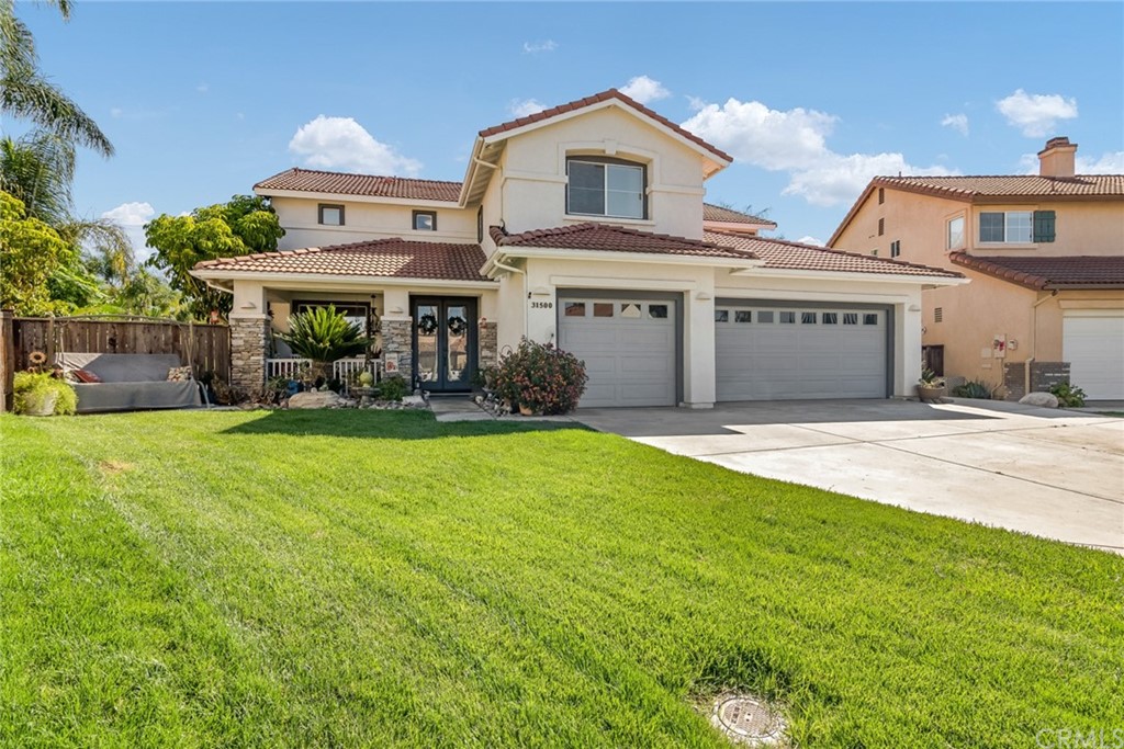 31500 Britton Circle Temecula, CA 92591 - Photo 62 of 68 a view of a white house with a big yard and large tree
