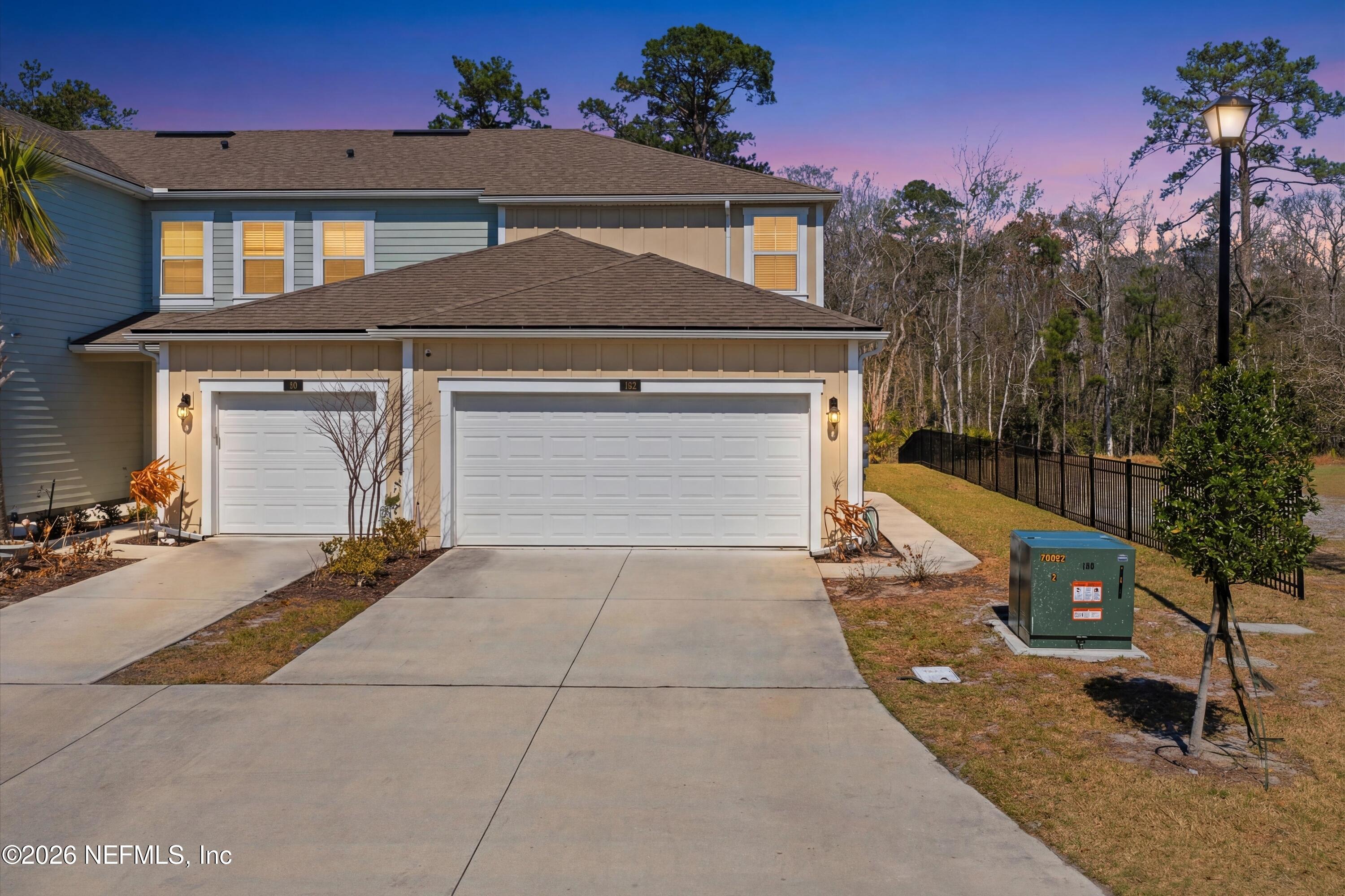 103 Seaport Breeze Road St. Augustine, FL 32095 - Photo 2 of 44 a front view of a house with a yard and garage