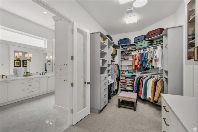 2608 Canyon Ridge Drive St. George, UT 84770 - Photo 40 of 86 Primary closet featuring abundant shelving, multiple hanging rods, built-in drawers, and carpet flooring