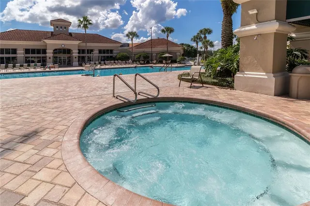 swimming pool view with a seating space