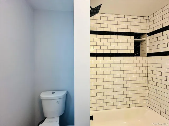 a bathroom with a toilet and shower
