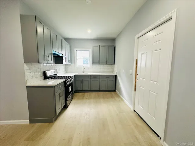 a large kitchen with cabinets and stainless steel appliances