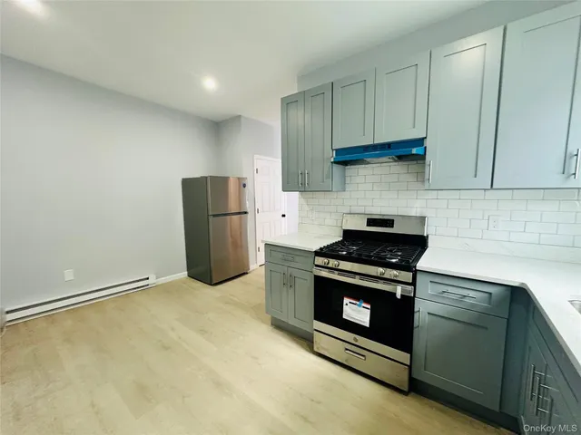 a kitchen with a stove and a refrigerator