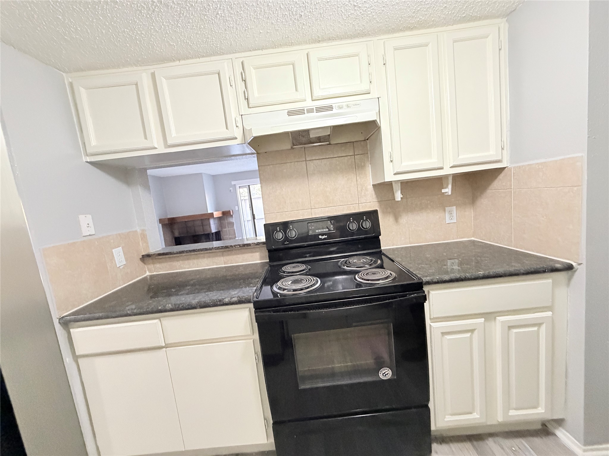 9461 Pagewood Lane, Unit 9461 Houston, TX 77063 - Photo 11 of 33 a kitchen with granite countertop white cabinets and appliances