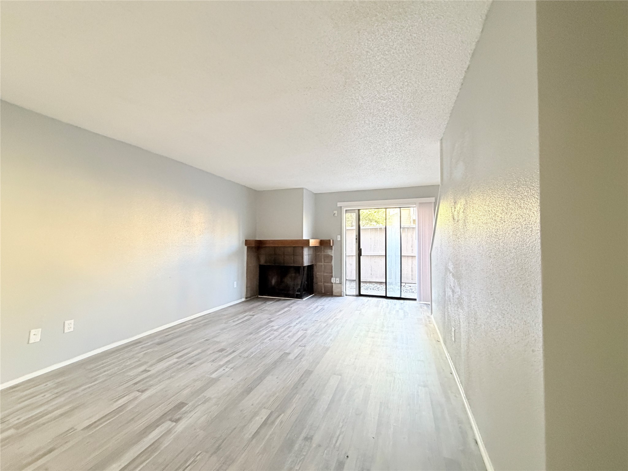 9461 Pagewood Lane, Unit 9461 Houston, TX 77063 - Photo 14 of 33 an empty room with wooden floor and windows