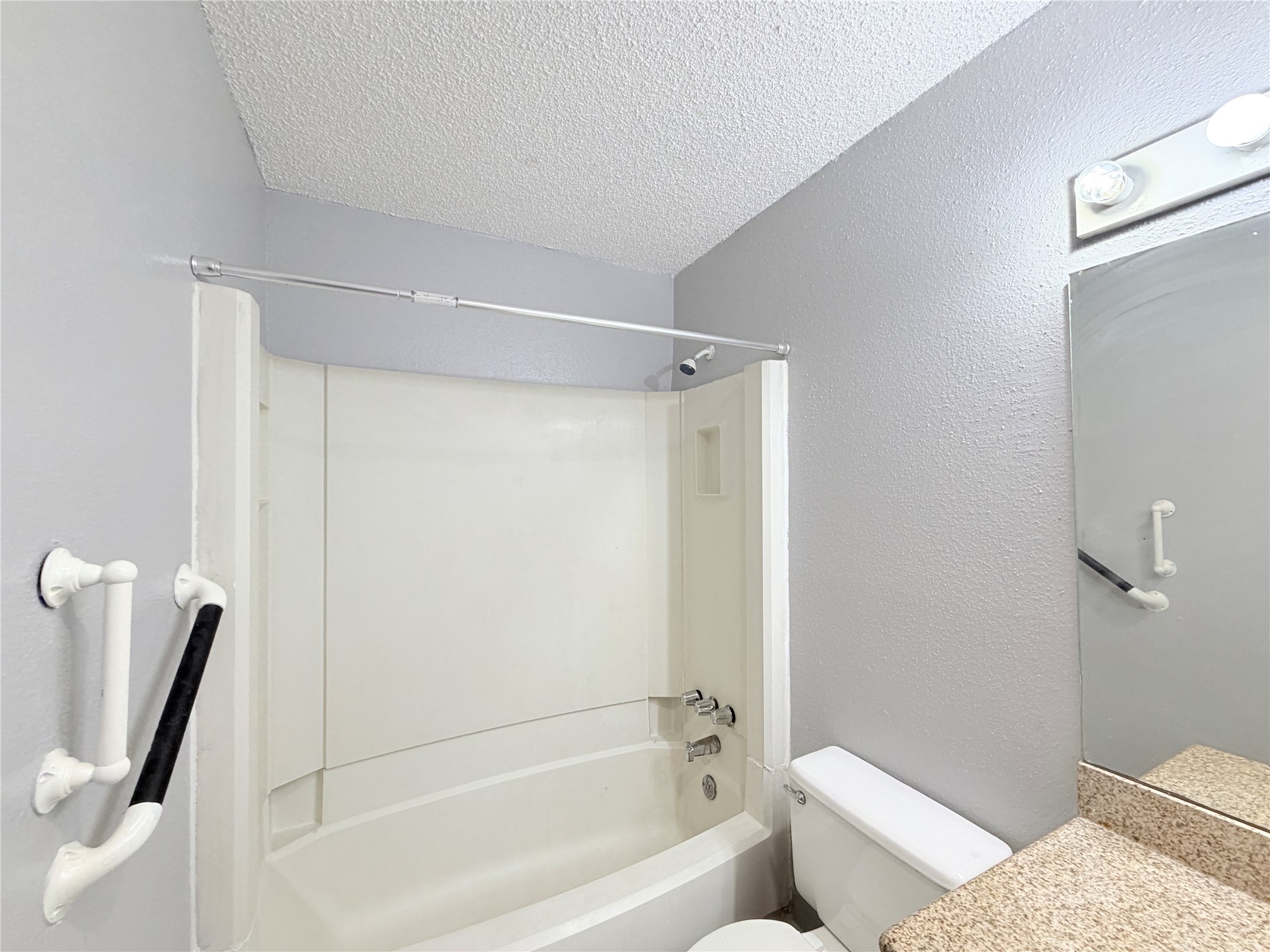 9461 Pagewood Lane, Unit 9461 Houston, TX 77063 - Photo 17 of 33 a bathroom with a shower and a toilet