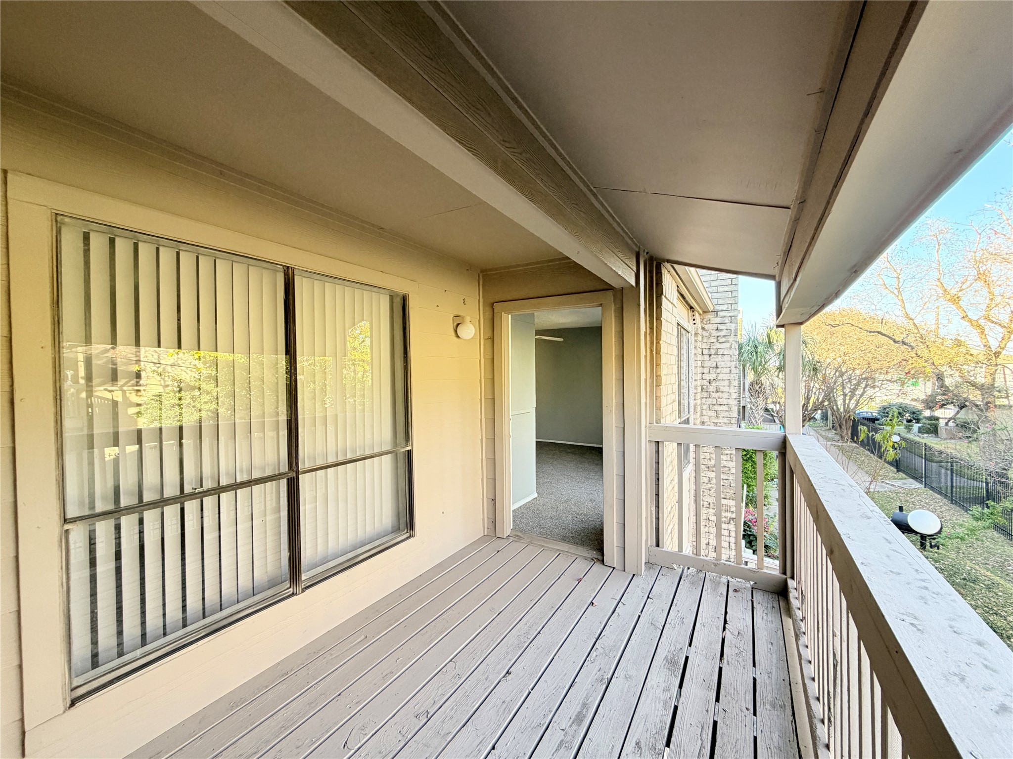 9461 Pagewood Lane, Unit 9461 Houston, TX 77063 - Photo 22 of 33 a view of a balcony with wooden floor