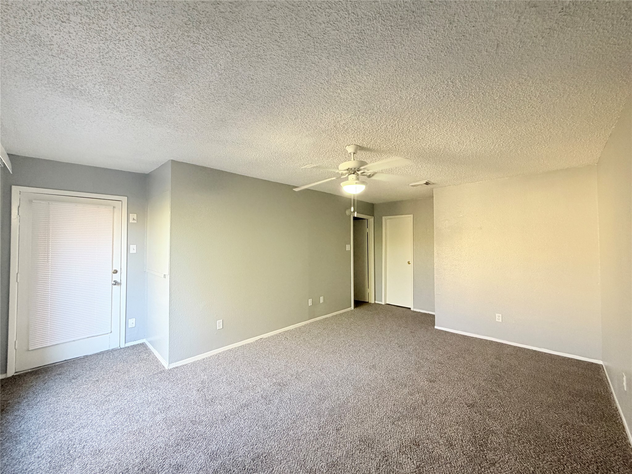 9461 Pagewood Lane, Unit 9461 Houston, TX 77063 - Photo 23 of 33 a view of an empty room with a chandelier fan