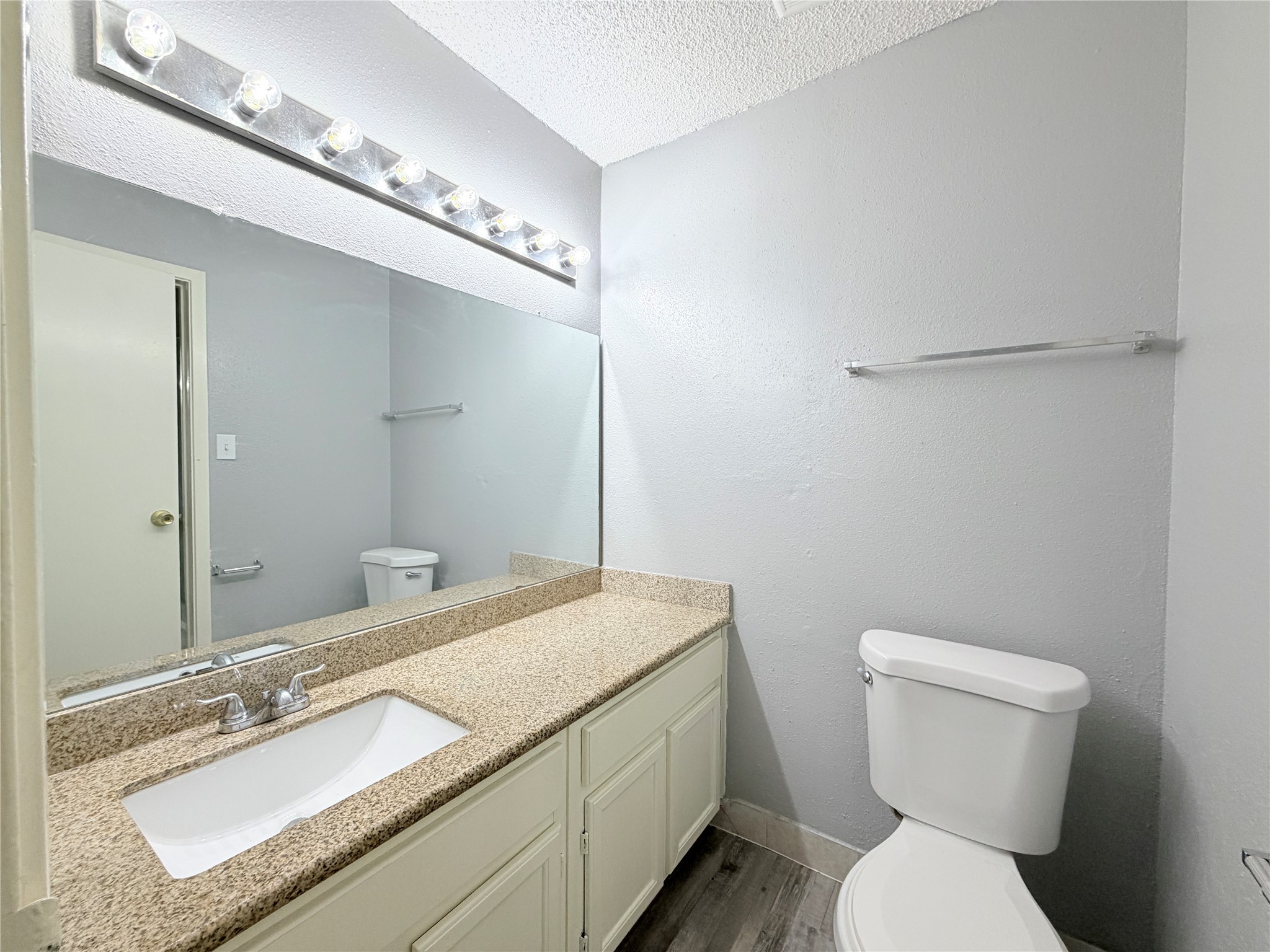 9461 Pagewood Lane, Unit 9461 Houston, TX 77063 - Photo 26 of 33 a bathroom with a granite countertop toilet sink and mirror