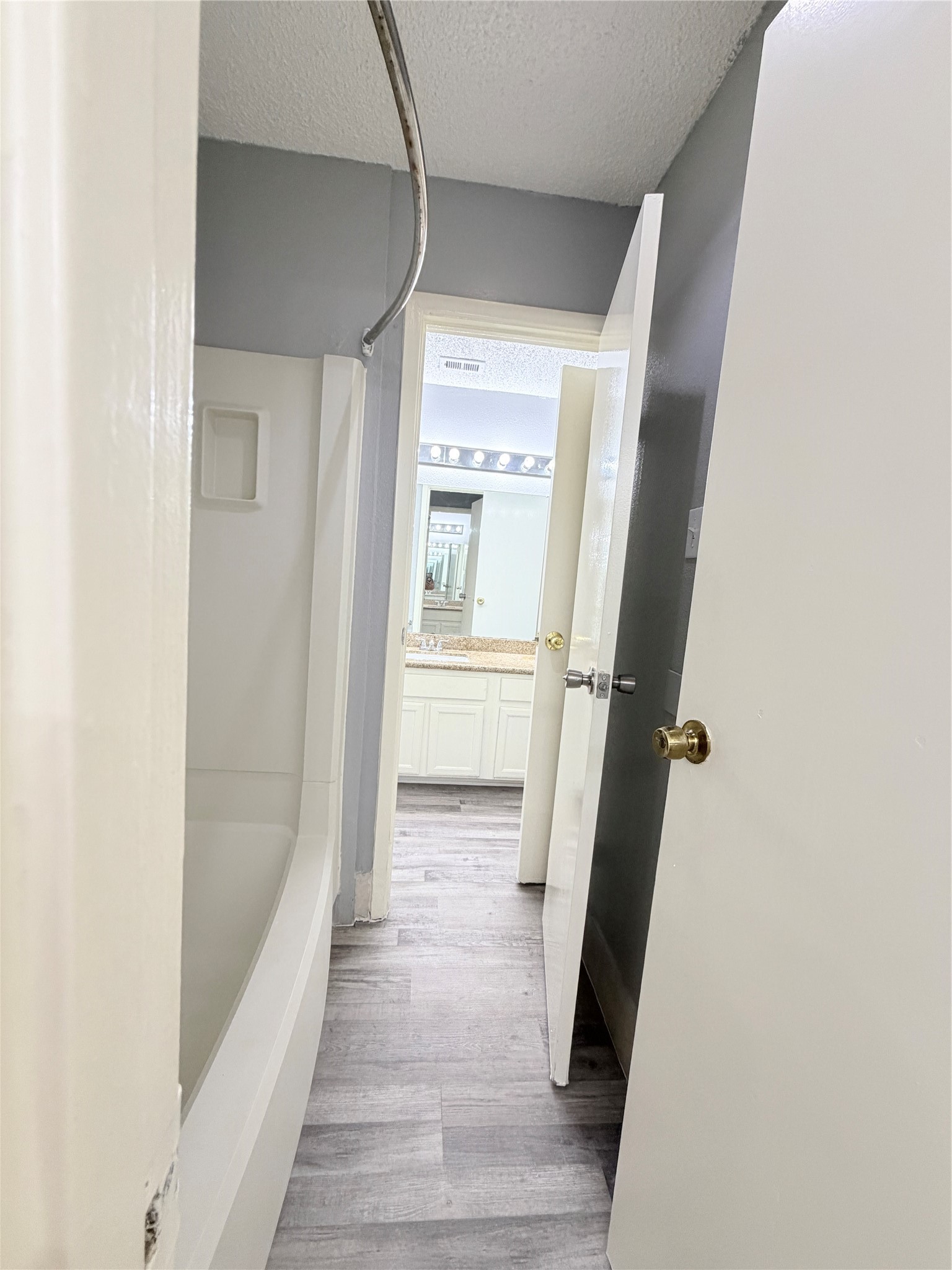 9461 Pagewood Lane, Unit 9461 Houston, TX 77063 - Photo 31 of 33 a view of a hallway with wooden floor and staircase