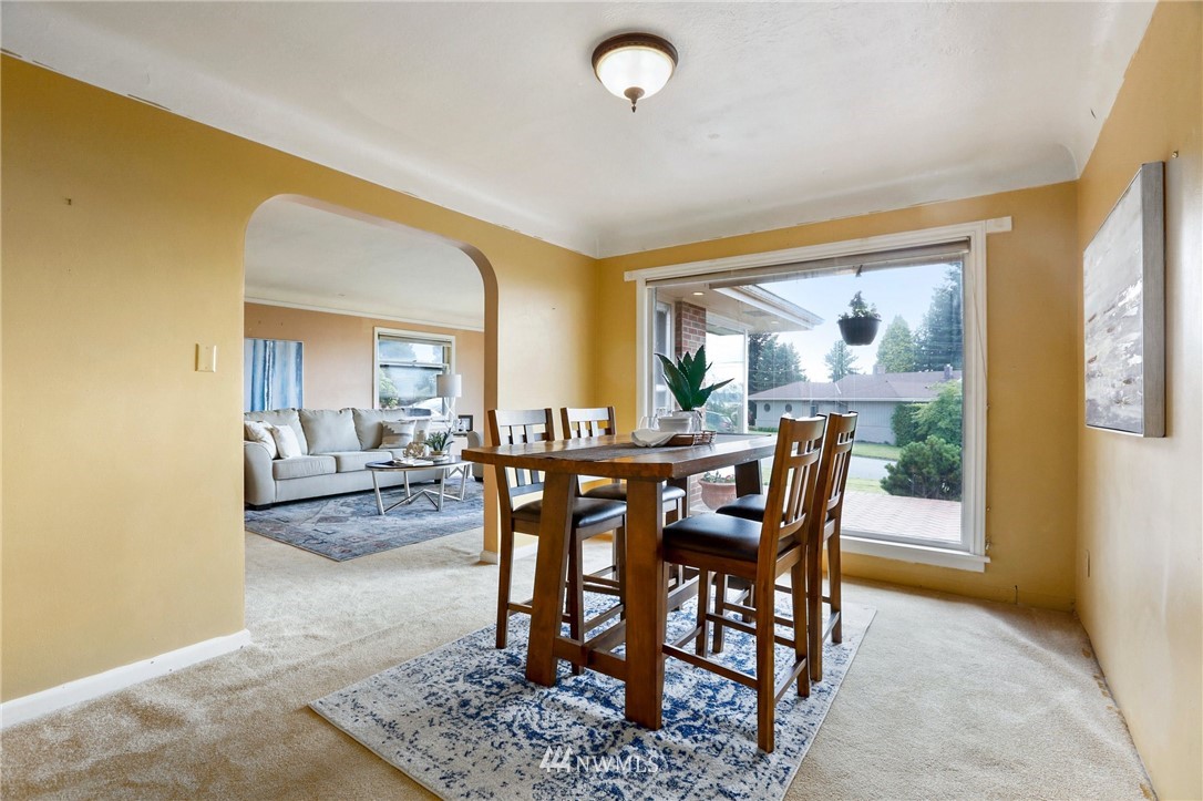 443 View Ridge Drive Everett, WA 98203 - Photo 14 of 35 a view of a dining room and livingroom with furniture wooden floor a rug and a painting