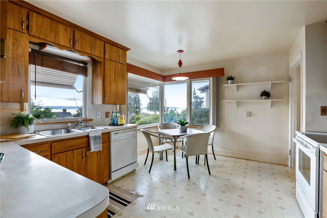 443 View Ridge Drive Everett, WA 98203 - Photo 19 of 35 a kitchen with a table chairs and a refrigerator