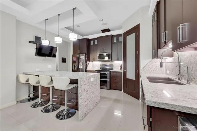 a kitchen with kitchen island granite countertop a table and chairs in it