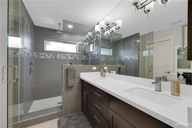 a bathroom with a sink double vanity and shower