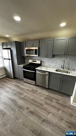 a large kitchen with cabinets a sink and a stove