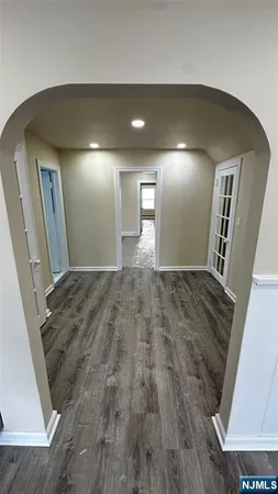 a view of hallway with wooden floor