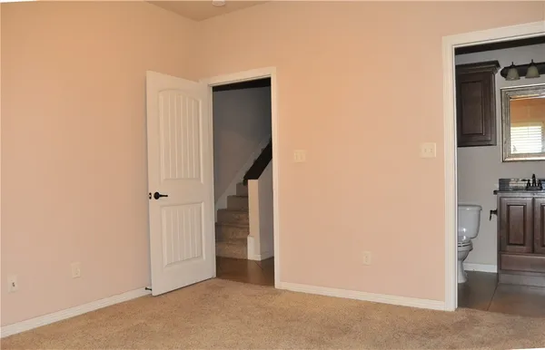 a view of a hallway with wooden shelves
