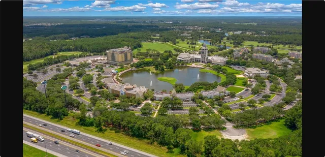 a front view of a multi story residential apartment building with yard and outdoor seating